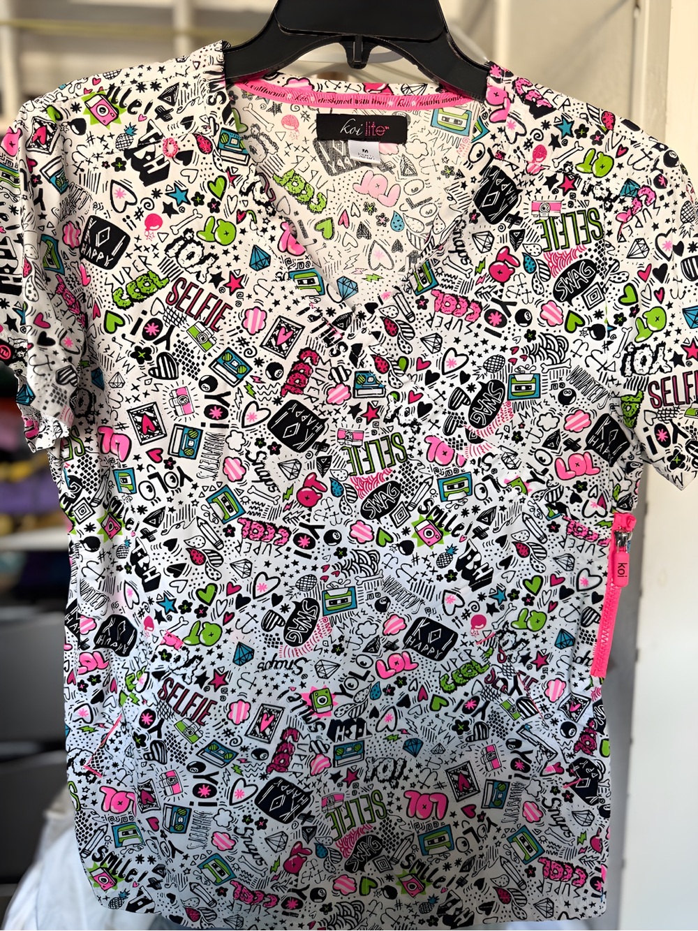 koi Women Scrub Top in White with Pink, Green, Black Accents